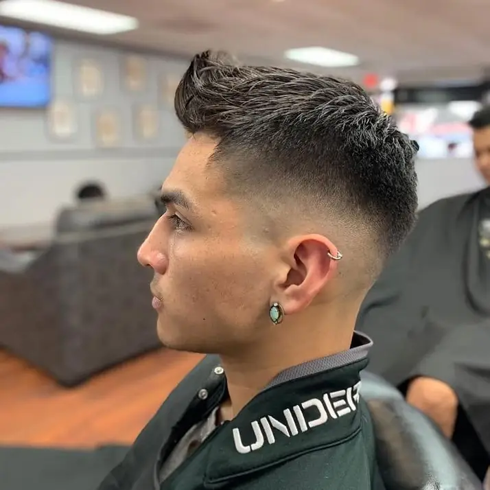 Mid fade with a textured pompadour on top