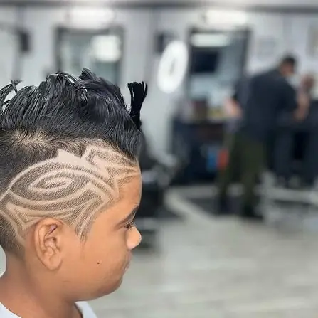 Kids haircut with a freestyle design shaved into the side