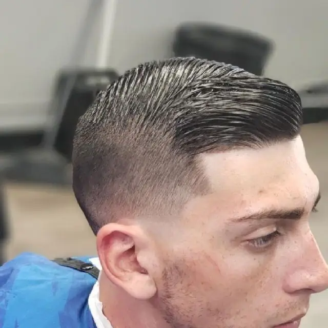 Skin fade with a hard part and slicked side part