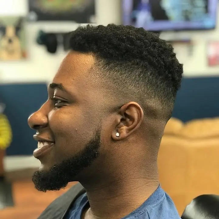 Sponge-twist top with a fade and a shaped full beard