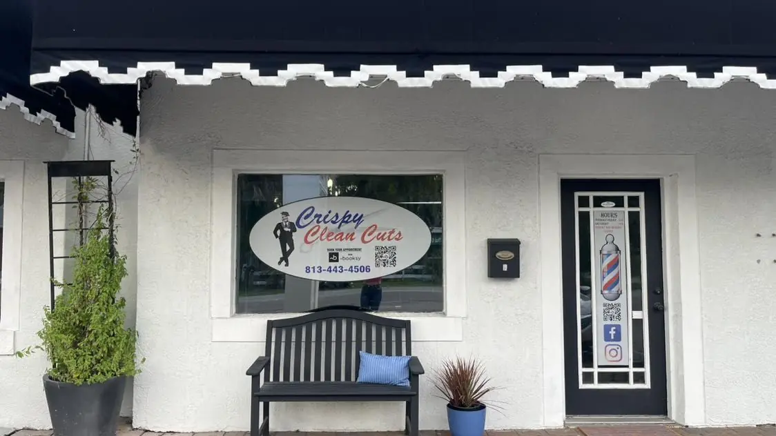 Crispy Clean Cuts storefront on S MacDill Ave with its sign, bench and barber pole